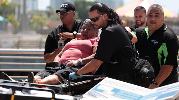 A passenger from the Caribbean Fantasy is carried on a stretcher after being rescued from the ship that was burning about two miles off of San Juan, Puerto Rico, Aug. 17, 2016.