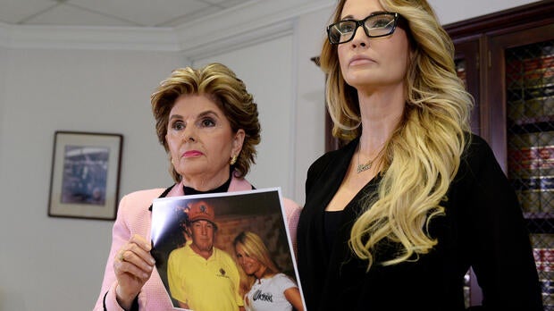 Lawyer Gloria Allred, left, holds a photograph of Jessica Drake and Donald Trump, taken in 2006 at a golf tournament in Lake Tahoe, California, after she spoke to reporters about allegations of sexual misconduct against Trump in Los Angeles, California, O