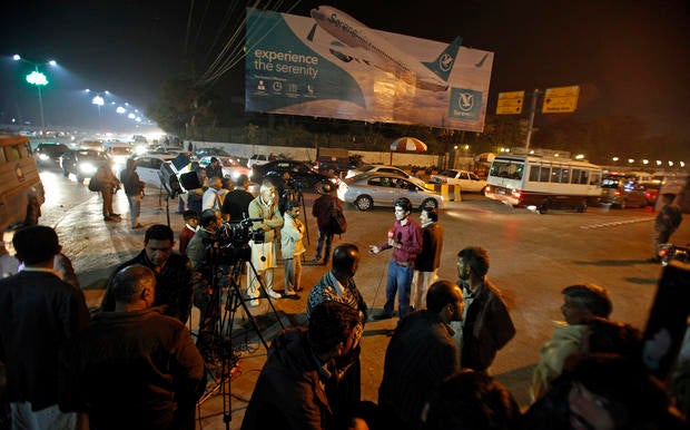 Pakistani media and residents gather at Benazir Bhutto International Airport following a report that a passenger plane from Chitral had crashed near a village near the town of Havelian, in Islamabad, Pakistan, Dec. 7, 2016.