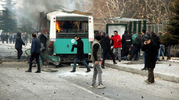 People react after a bus was hit by an explosion in Kayseri, Turkey, Dec. 17, 2016.