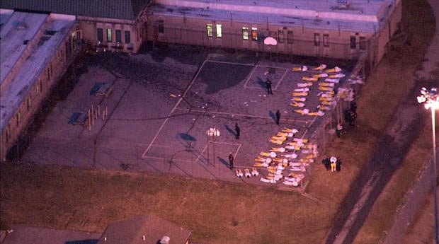 Inmates lie on the ground at James T. Vaughn Correctional Center in Smyrna, Delaware, on Feb. 2, 2017, after a disturbance that started a day earlier.
