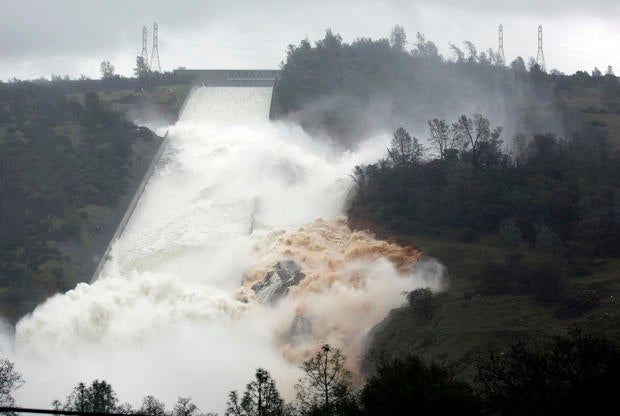 Water flows through a break in the wall of the Oroville Dam spillway Feb. 9, 2017, in Oroville, Calif.