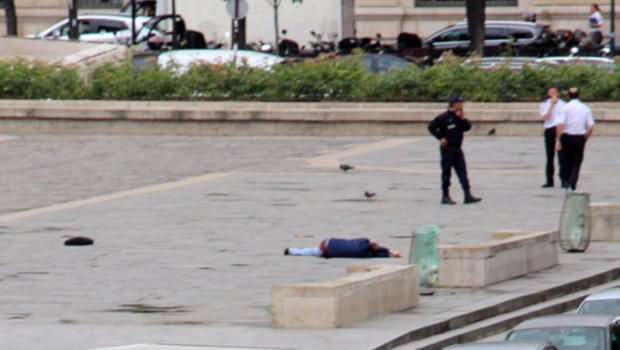 A man lies on the ground outside Notre Dame Cathedral after attacking police officers in Paris on June 6, 2017, in this picture provided to CBS News. 