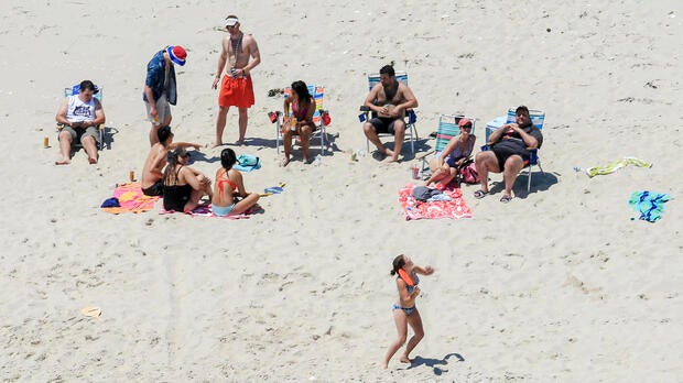 In this July 2, 2017, photo, New Jersey Gov. Chris Christie, right, uses the beach with his family and friends at the governor's summer house at Island Beach State Park in New Jersey.