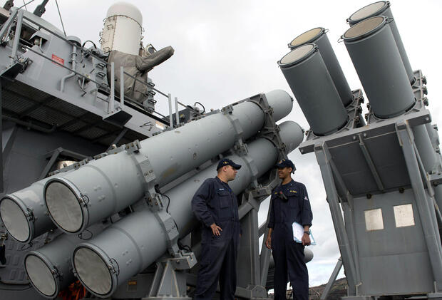 U.S. Navy personnel stand in front of a guided missile launcher during a bilateral maritime exercise between the Philippine navy and U.S. Navy aboard the USS John S. McCain in the South China Sea near waters claimed by Beijing on June 28, 2014.