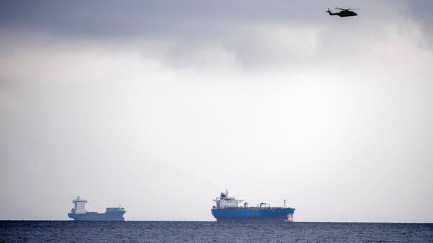 A helicopter searches the area off of Copenhagen Harbour where the Nautilus, considered the largest privately built submarine of its kind, was reported missing near Copenhagen, Denmark, Aug. 11, 2017.