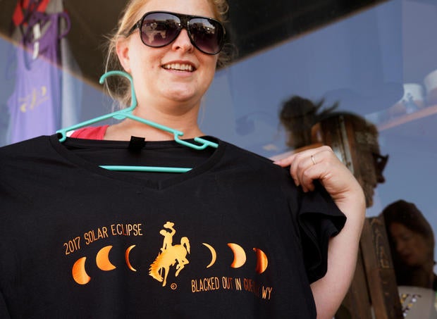 Melissa Howe displays one of her eclipse t-shirts designs in Guernsey