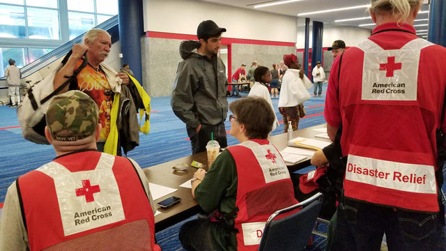 Evacuees arrive to seek shelter with Red Cross volunteers at the George Brown convention center after flood waters of Hurricane Harvey forced them to leave their homes in Houston 