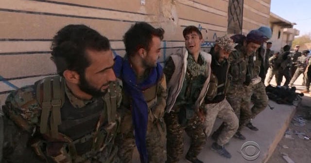 Syrian fighters celebrate in Raqqa after driving out ISIS