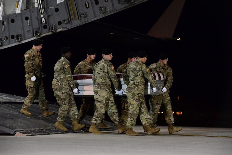 A U.S. Army carry team transfers the remains of Army Staff Sgt. Dustin Wright at Dover Air Force Base in Delaware