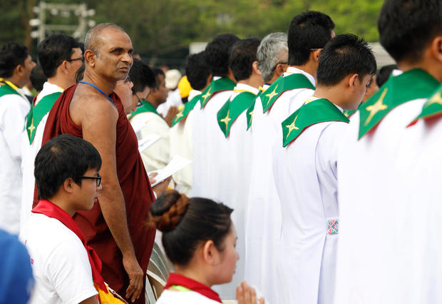 Faithful attend a mass led by Pope Francis at Kyite Ka San Football Stadium in Yangon, Myanmar 