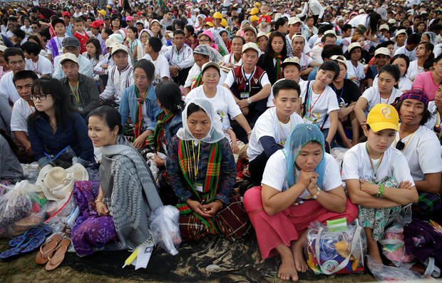 Catholic faithful attend a mass led by Pope Francis at Kyite Ka San Football Stadium in Yangon, Myanmar 