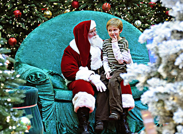 A young boy tries to tell Santa Claus wh 