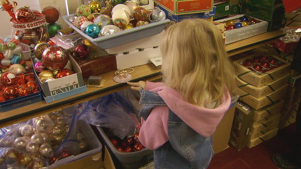 a-little-girl-chooses-ornaments-at-the-annual-christmas-tree-project-giveaway-credit-cbs-news.jpg 