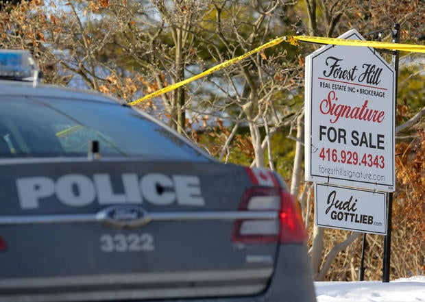 A police vehicle is parked outside the home of billionaire founder of Canadian pharmaceutical firm Apotex Inc. in Toronto