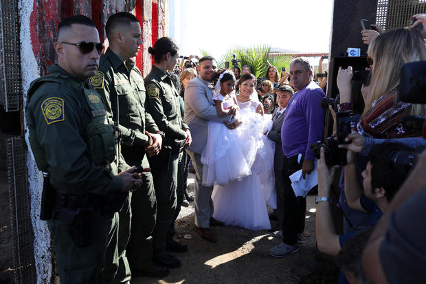 U.S. resident Brian Houston marries Evelia Reyes as U.S. Border Patrol agents open a single gate in the border wall to allow selected families to visit along the U.S.-Mexico border in San Diego 