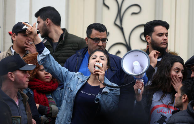 Graduate shouts slogans during protests against rising prices and tax increases, in Tunis 