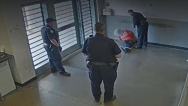 Corrections Officer Seen On Video Striking Shackled Hooded Inmate Cbs News