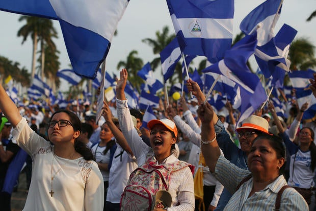 People take part in a protest march to demand an end to violence in Managua