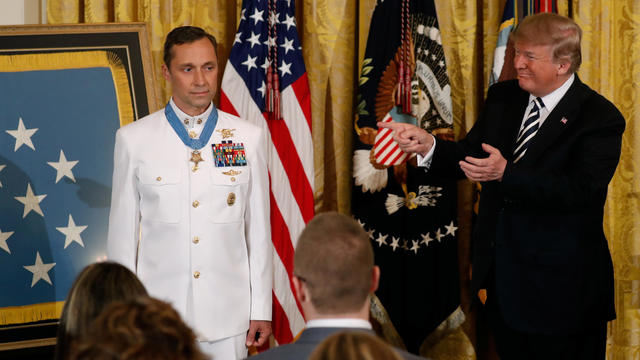 U.S. President Donald Trump gestures after awarding the Medal of Honor to Retired Navy Master Chief Special Warfare Operator Britt Slabinski for “conspicuous gallantry” in the East Room of the White House in Washington 