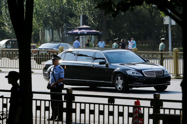 A car believed to be carrying North Korean leader Kim Jong Un drives down Chang'an Avenue towards Tiananmen Square in Beijing 