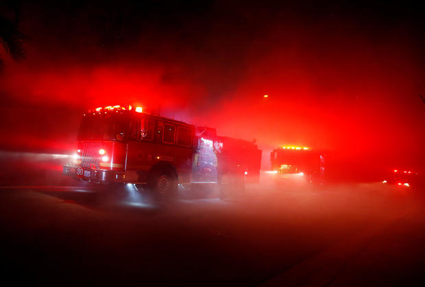 Firefighters battle flames overnight during a wildfire that burned dozens of homes in Thousand Oaks 