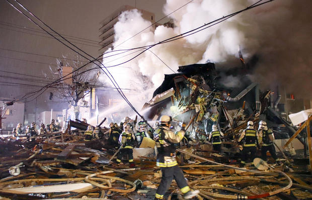 Firefighters operate at the site where a large explosion occurred at a restaurant in Sapporo, Hokkaido 