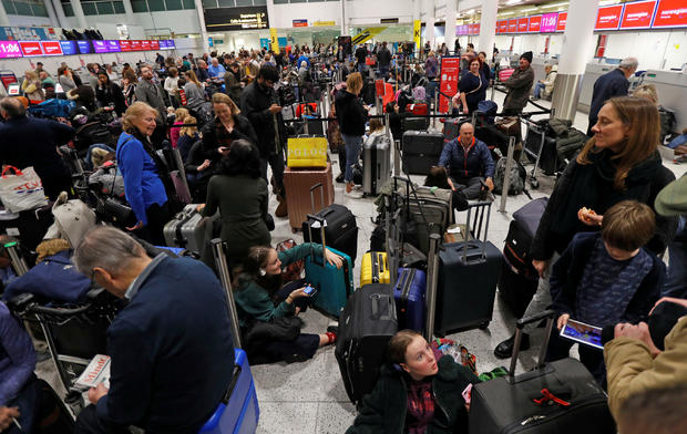 Passengers wait around in the South Terminal building at Gatwick Airport after drones flying illegally over the airfield forced the closure of the airport, in Gatwick 