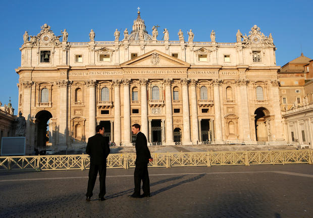 Two men talk in front of the Saint Peter's Basilica ahead of a four-day meeting on the global sexual abuse crisis, held by Pope Francis, at the Vatican 