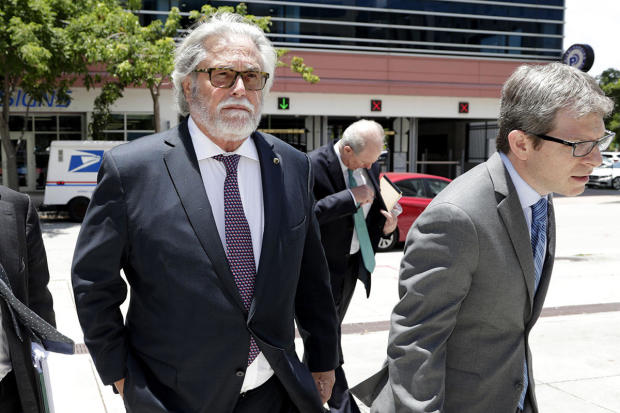 Carnival Corp. President Micky Arison, left, arrives in federal court on June 3, 2019 in Miami. 