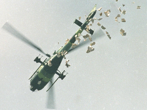 FILE PHOTO: A military helicopter drops leaflets above Tiananmen Square in Beijing 