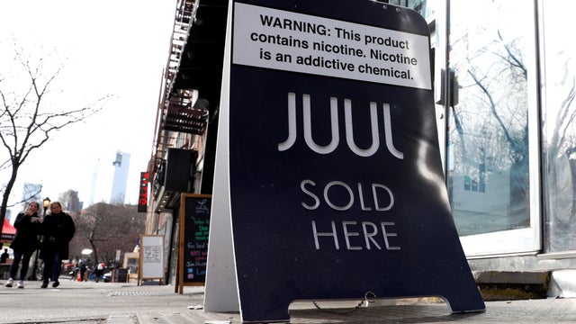 A sign advertising Juul brand vaping products is seen outside a shop in Manhattan in New York City