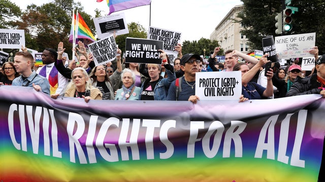 LGBTQ activists and supporters block the street outside the U.S. Supreme Court as it hears arguments in a major LGBTQ rights case on whether a federal anti-discrimination law that prohibits workplace discrimination on the basis of sex covers gay and trans 
