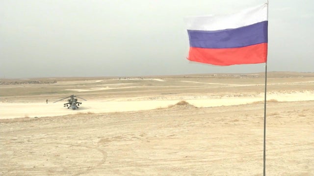 A Turkish military truck drives on the Turkish-Syrian border, with the Syrian town of Kobani in the background, in Suruc 