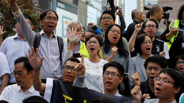 Pro-democratic winning candidates gather outside the campus of the Polytechnic University (PolyU) in Hong Kong