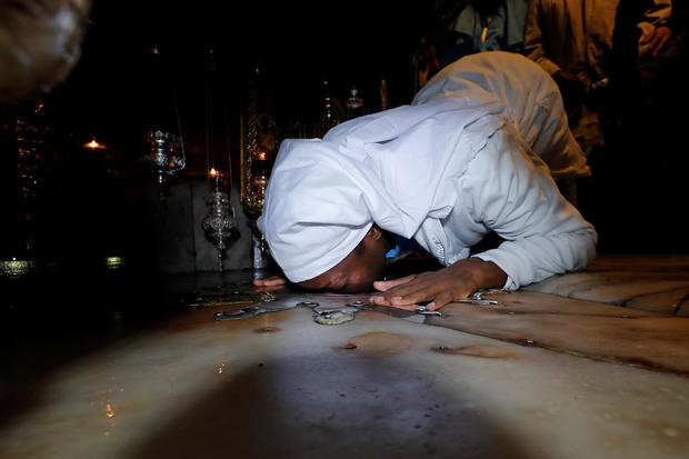 Worshipper kisses the star inside the Church of the Nativity on Christmas eve in Bethlehem, in the Israeli-occupied West Bank 