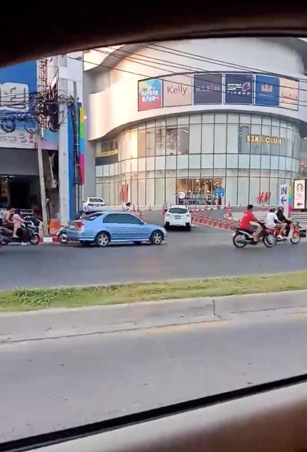 A person runs away from a shopping mall during a shooting rampage in Nakhon Ratchasima 