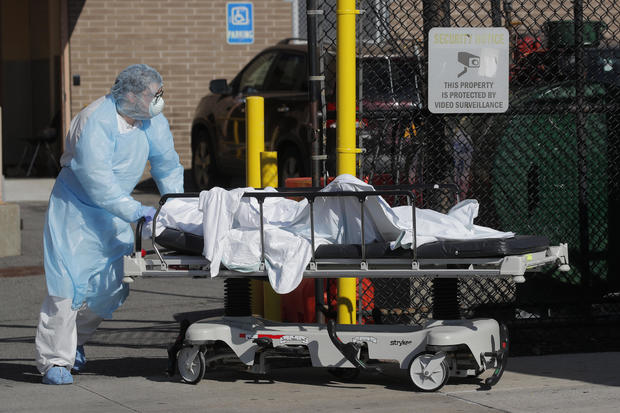 Healthcare worker wheels body of deceased person from Wyckoff Heights Medical Center during outbreak of coronavirus disease (COVID-19) in New York 