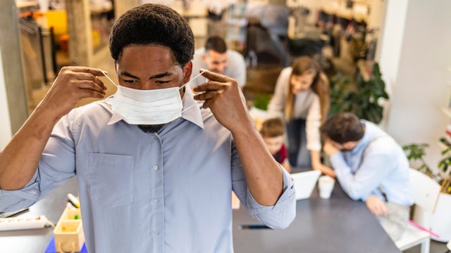 Adult man wearing a pollution mask to protect himself from viruses 