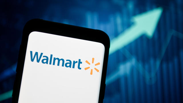 In this photo illustration a Walmart logo seen displayed on 