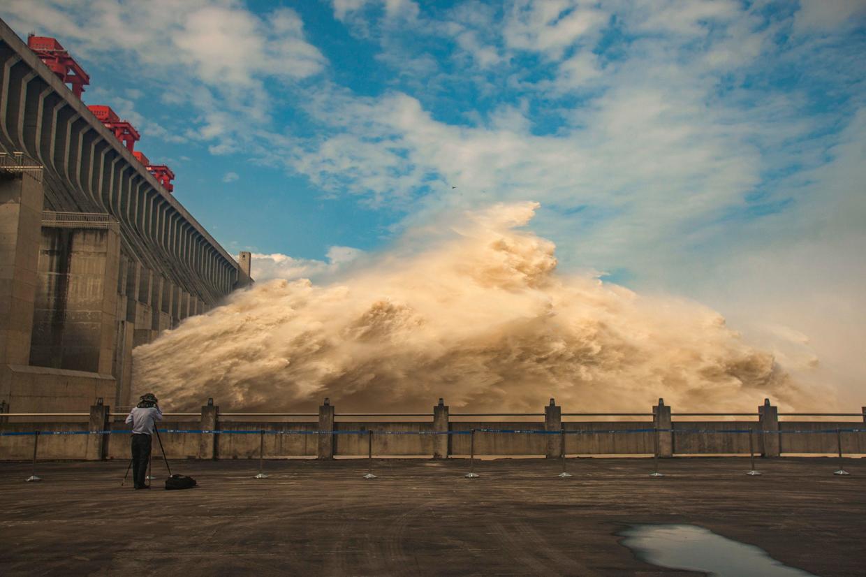 Thousands evacuated as floods threaten a massive dam and a treasured