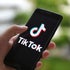 In this photo illustration a TikTok logo displayed on a 