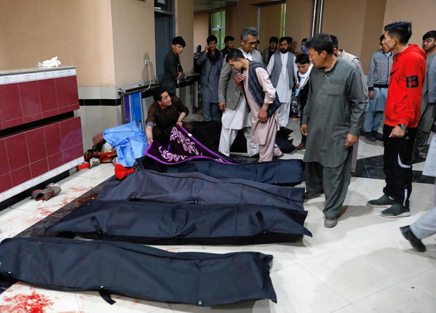 Afghan men look for their relatives at a hospital after a suicide bombing in Kabul 