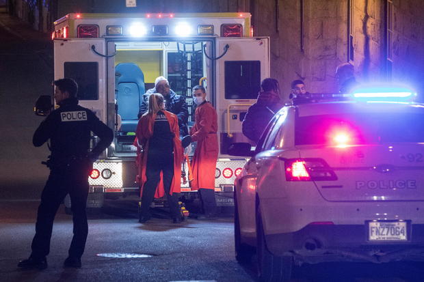 A person is treated by an ambulance crew in an area where multiple people were stabbed in Quebec City 
