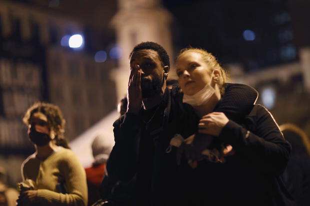 Couple Pascale Hutton and Iman James react emotionally outside the State Capitol building while watching Biden's speech after news media declared Democratic candidate Joe Biden to be the winner of the 2020 U.S. presidential election, in Harrisburg 
