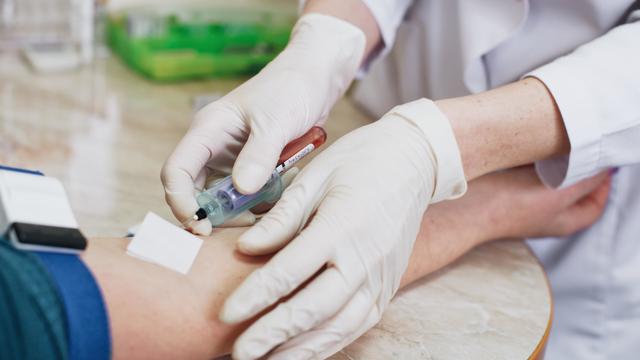 Cropped Hands Of Doctor Injecting Syringe On Patients Hand During Blood Test 
