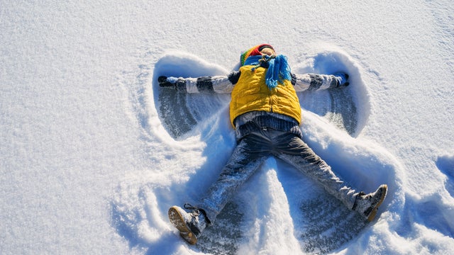 Boy making a snow angel 