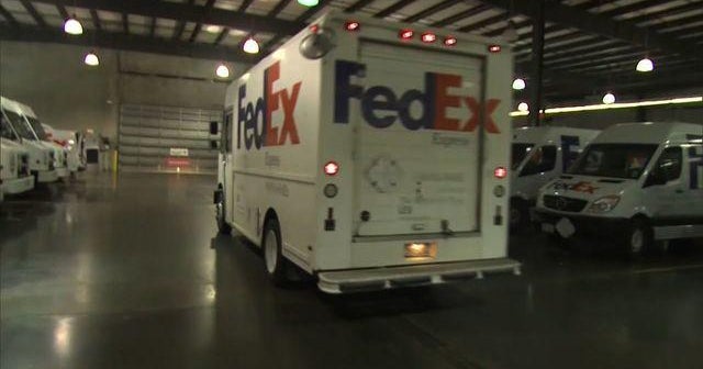 MoneyWatch: FedEx charged with distributing prescription drugs; Malaysia Airlines crash sends stocks tumbling