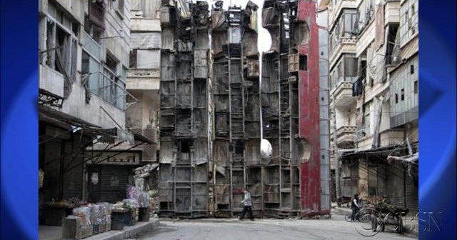 Incredible photo: Syrians using bus shells as shelling barricades