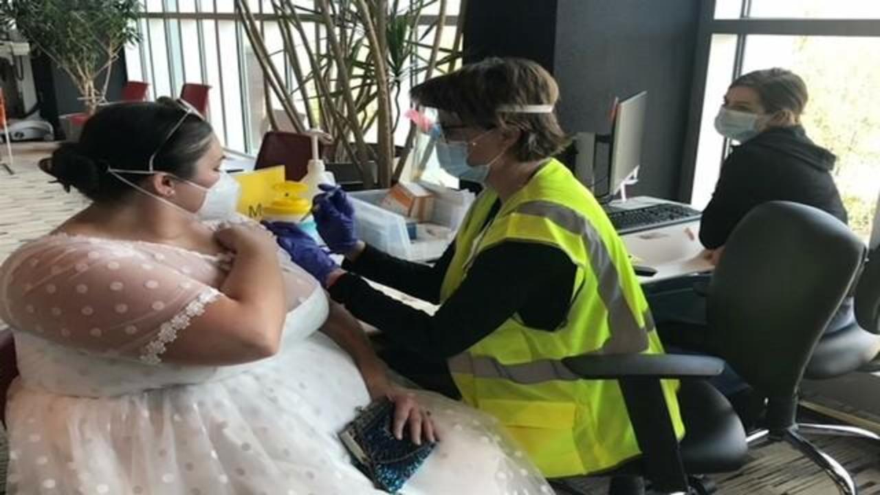 This bride's reception got canceled because of the pandemic — so she put on her wedding dress to get the COVID vaccine - CBS News